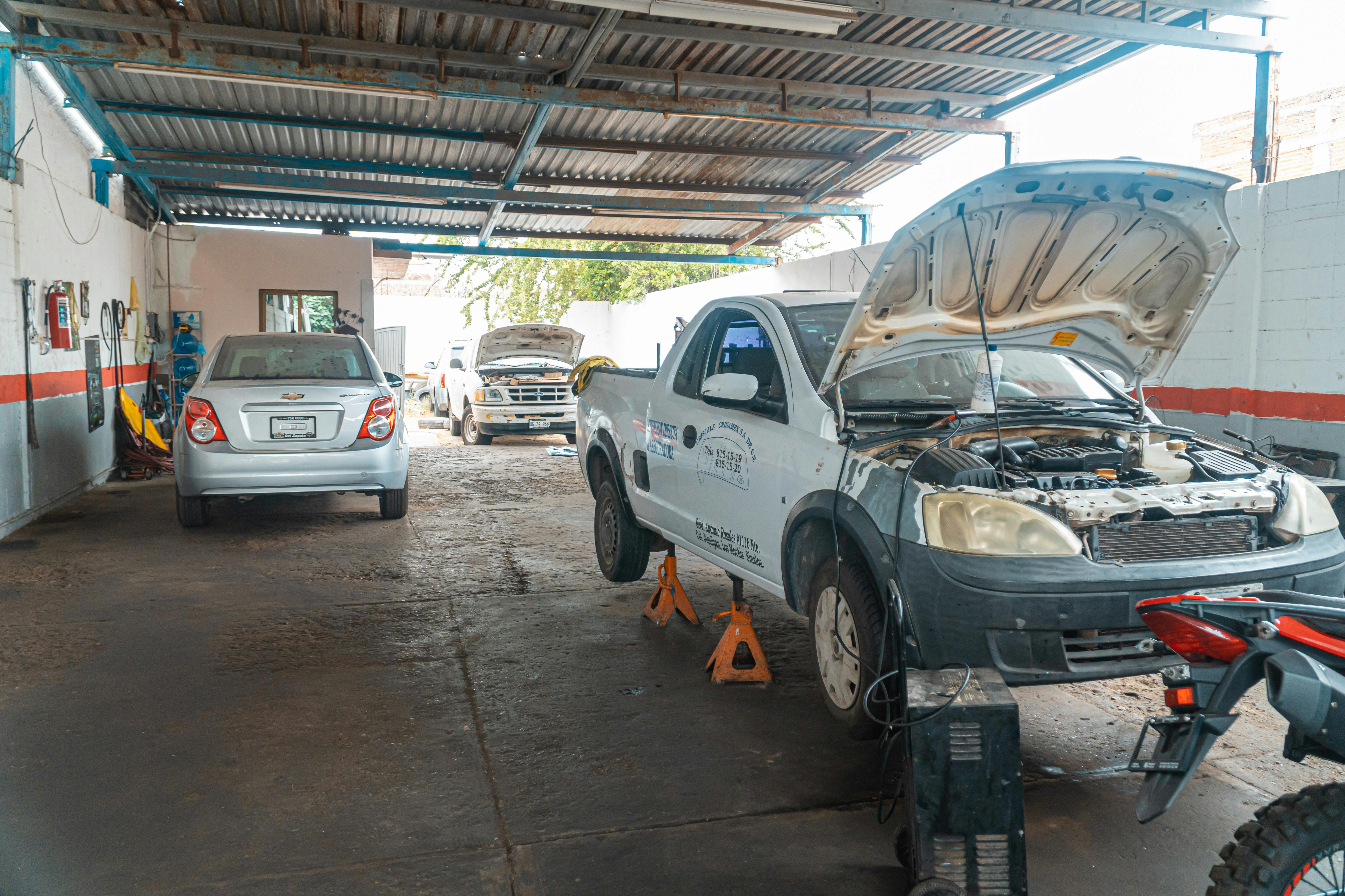 Mechanic inspecting a vehicle in the workshop